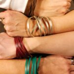 Poignet portant un bracelet semainier composé de sept joncs superposés.